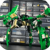 a green lego dragon is sitting on top of a shelf